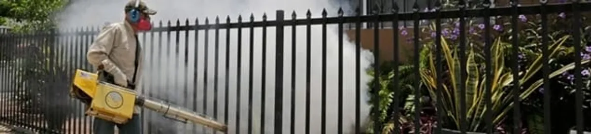 Mosquito control technician fogging a yard perimeter for mosquito reduction in Pueblo, CO